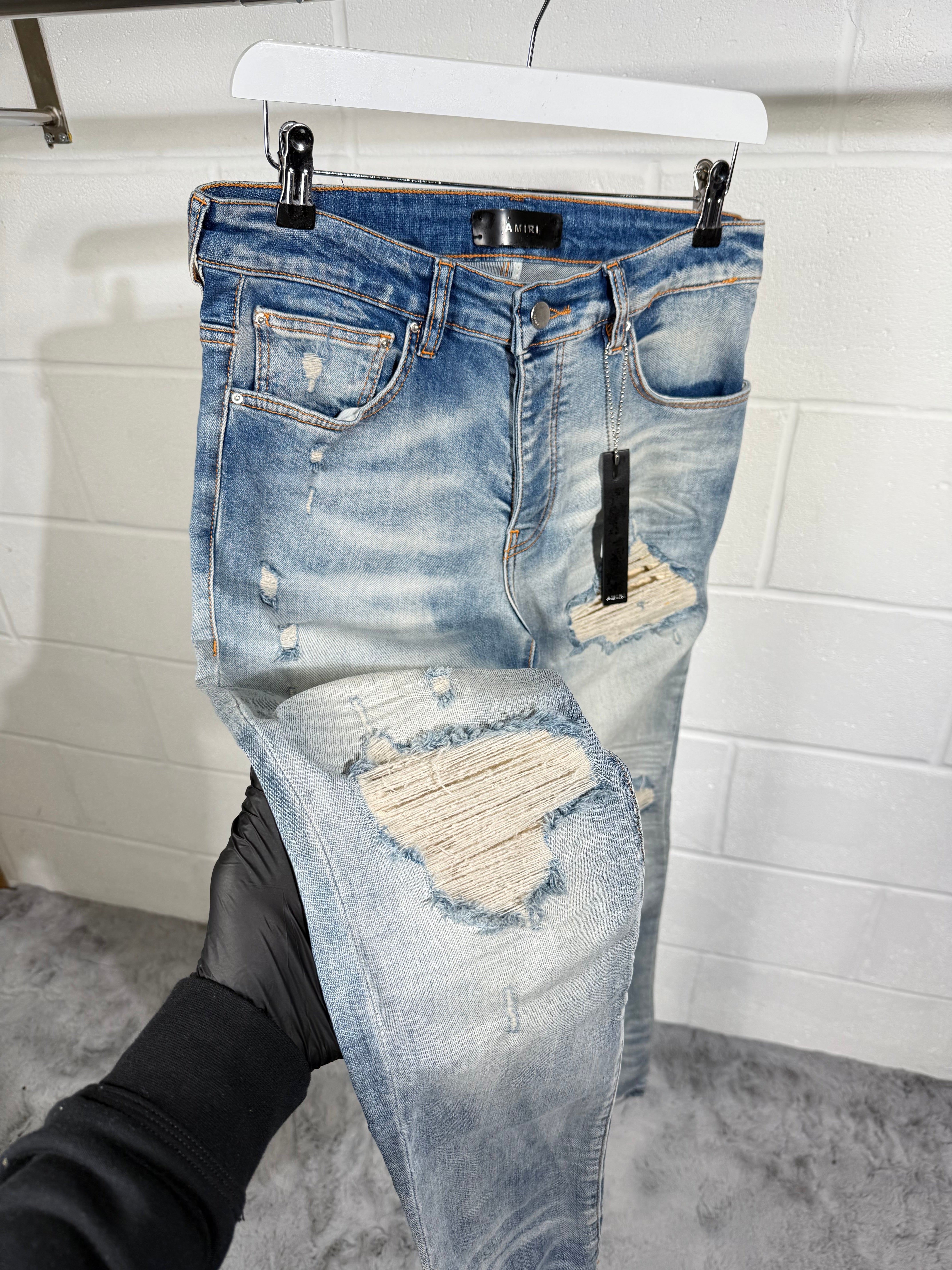 AMIRI RIPPED JEANS LIGHT BLUE