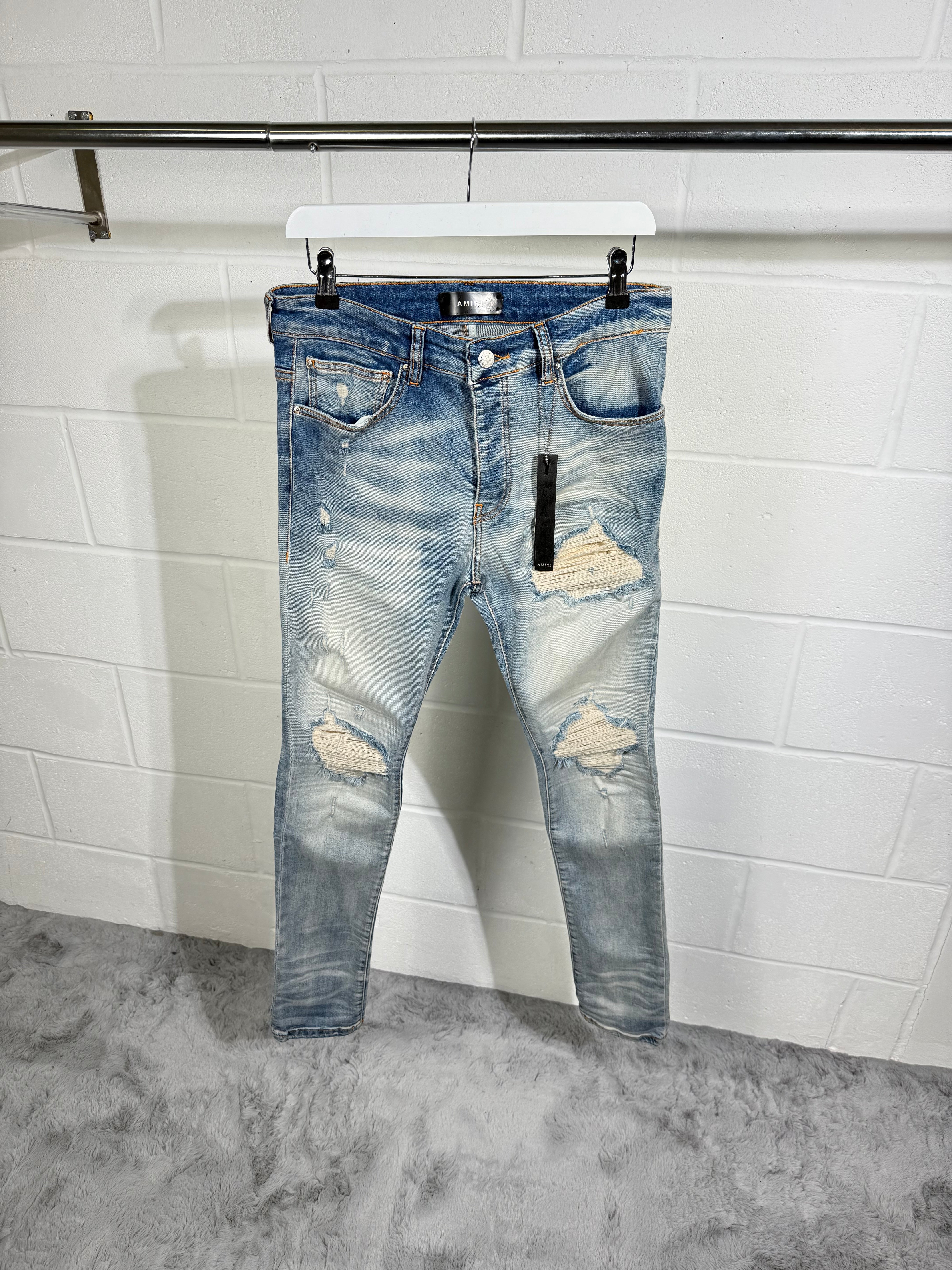 AMIRI RIPPED JEANS LIGHT BLUE